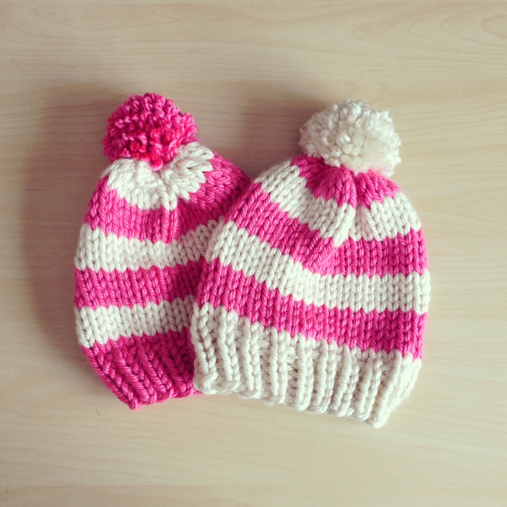2 striped classic pom-pom beanies in opposite color schemes