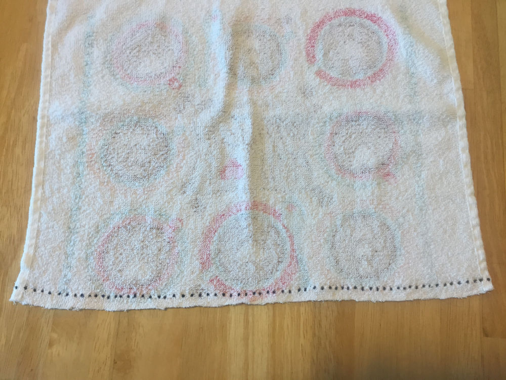 dots used as markers along the edge of towel