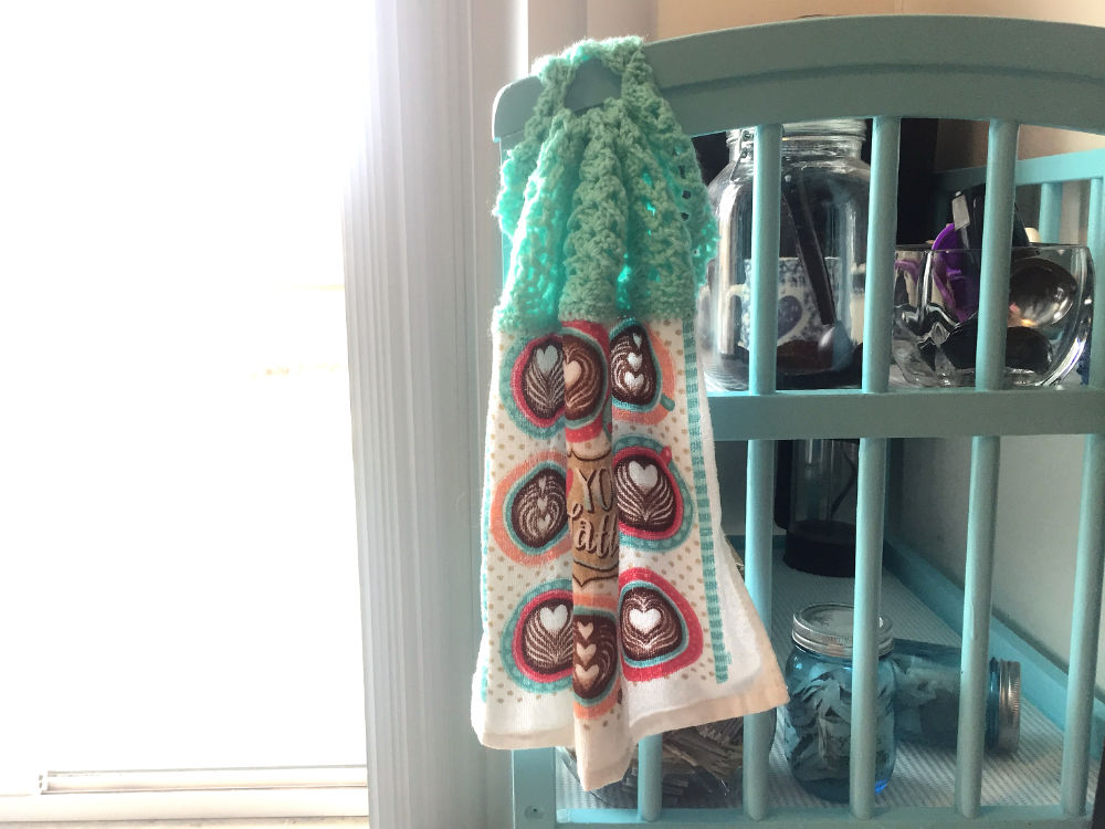 crochet topped tea towel handing on stand