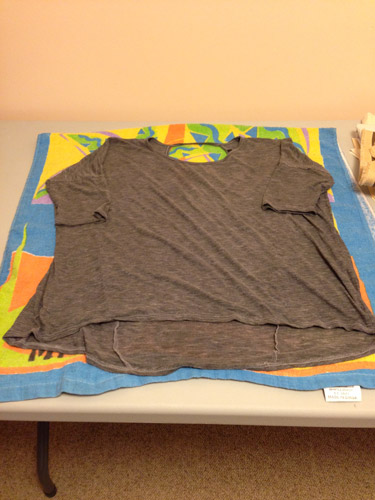 Fixing shrunken clothing: lay the wet shirt on a towel